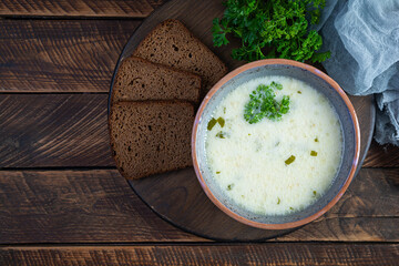 Delicious creamy beef soup. Vegetable creamy soup with beef, herbs and bread. Top view