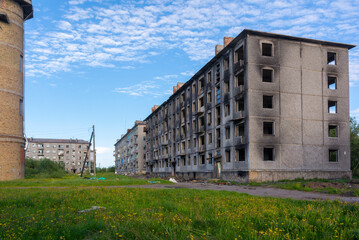 Empty streets of the abandoned settlement of Severny in the north. Burnt down apartment building. Russia
