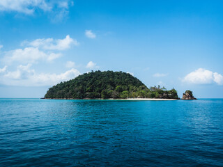 Scenic view of lonely small tropical island in the middle of sea against blue sky in summer. Ko Rayang Nok, near Ko Mak Island, Trat, Thailand.