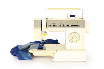 Piece of fabric on a sewing machine isolated on completely white background. Contains clipping path