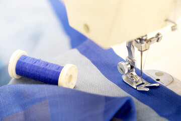 Detail of a sewing machine and a piece of fabric