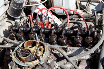 Disassembled carburetor motor. Cylinder head with rocker shaft installed on engine. DIY repair....