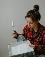 woman at home with paint brush