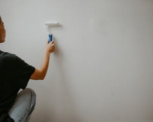 woman at home with paint brush