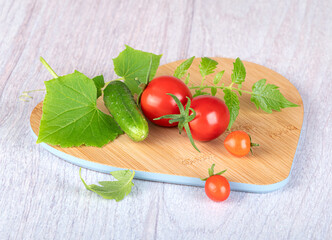 A beautiful young red bell pepper with a cut top and a green branch on a white background with a shadow