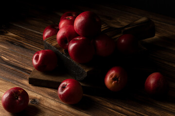 Fresh red apples on wooden table. On wooden background.