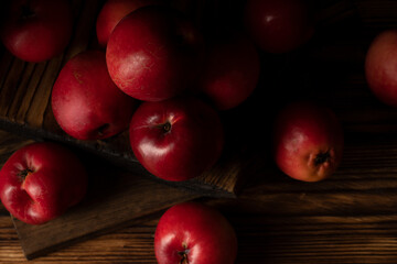 Fototapeta na wymiar Fresh red apples on wooden table. On wooden background.