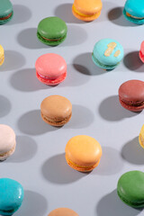 assorted colorful french macarons on background pattern