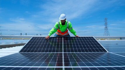 solar panel installation. Asian man engineer service check installation solar cell on the roof of...