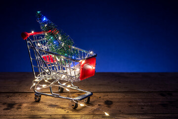 Shopping concept image with a shopping cart and christmas led lights