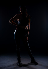 Fototapeta na wymiar Silhouette of a girl posing in studio