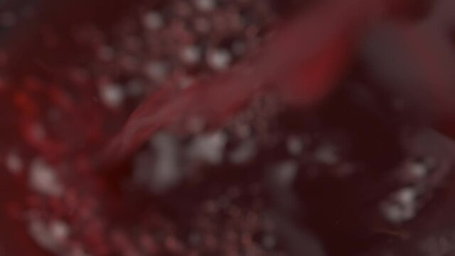 Pouring red grape juice into a glass. 4k. Slow motion