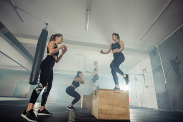 Fitness group of  strong women having cross-functional training in the gym