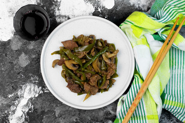 Beef and stir fried vegetables: mushrooms and green bell peppers