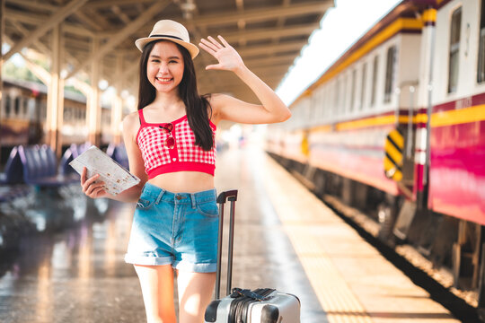 Woman traveler with bag, luggage, arrival  traveling, travel, trip for woman concept, say hi, good bye to friend.trip in summer with face mask for protection by infection from Coronavirus, Covid-19