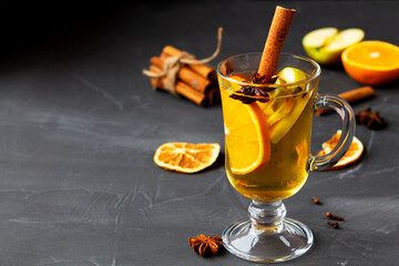 Mulled drink with copy space. Christmas hot white mulled wine in glass with orange, honey, cinnamon...