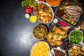 Thanksgiving dinner table with new traditional thanksgiving food - chicken, mashed sweet potatoes, green beans, pecan pie, baked ham pork, mac and cheese, stuffing, modern hard sunny light flatlay