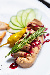 Foie gras paste with rosemary herb. Delicious duck liver mousse served with cranberry sauce and...