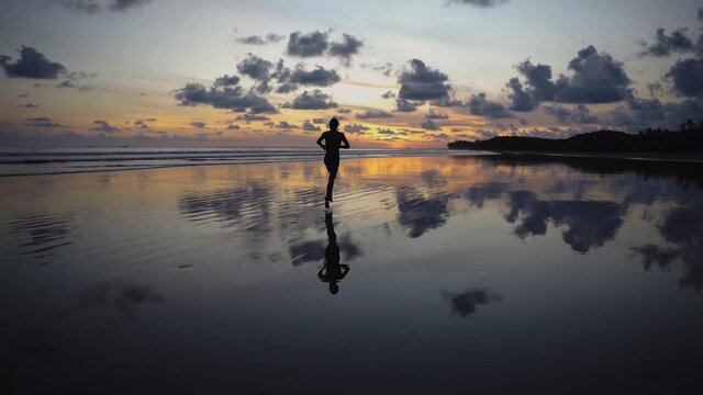Running on the beach with a stunning sunset