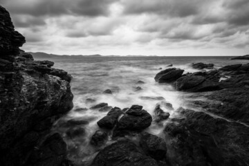 Sea rocks with wave on sunset