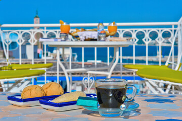 A cup of coffee with traditional Moroccan biscuits. Moroccan decoration. Tasty food breakfast.