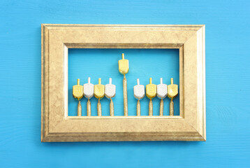 Image of jewish holiday Hanukkah with wooden dreidels collection (spinning top) as menorah