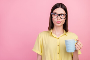 Photo of young attractive girl curious interested look empty space think mug tea isolated over pink color background