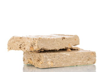 Two pieces of halva with peanuts , close-up, isolated on white.