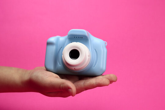 plastic toy camera for children on a red background, horizontal banner