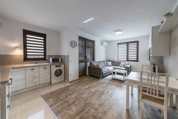New modern living room with kitchen. New home. Interior photography. Wooden floor.