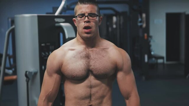 Muscular arab man training with dumbbells in the gym.