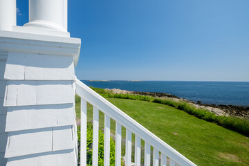The porch and wooden railing with a view of the St George harbor at the Marshalls Point Lighthouse...