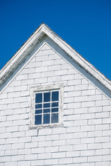 Abandoned  brick A-frame with a square window