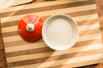Sugar and refined sugar are poured into the sugar bowl on the table.