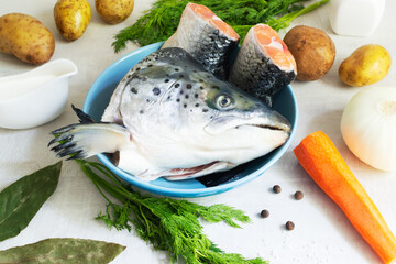Ingredients for preparing fish soup: salmon, potatoes, carrots, onions, a bunch of dill, bay leaves and peppers. Lohikeitto is a traditional Finnish and Karelian soup.
