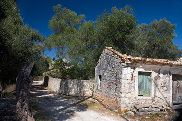Fototapeta na wymiar An abandoned, roofless cottage in the tiny hamlet of Ozias in the south of the island of Paxos, Ionian Islands, Greece