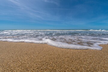 Sea with waves in the foreground on the shoreline