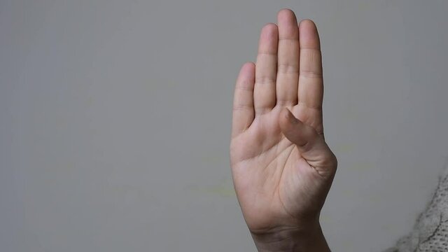 Signal for help concept: slow motion of a woman that shows how to make the gesture to ask help silently