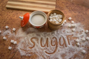 The inscription sugar on the table, refined sugar in a sugar bowl.