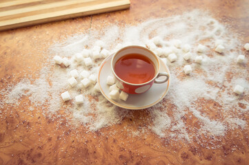 Sugar and refined sugar scattered on the table top view.