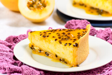 SLICE OF PASSION FRUIT PIE ON A WHITE PLATE, PHOTOGRAPHED IN CLOSE-UP WITH SELECTIVE FOCUS