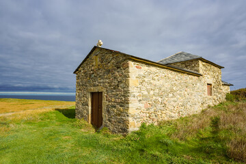 Fototapeta na wymiar Santa Comba hermitge Christian chapel by Atlantic Ocean in Galicia, Spain