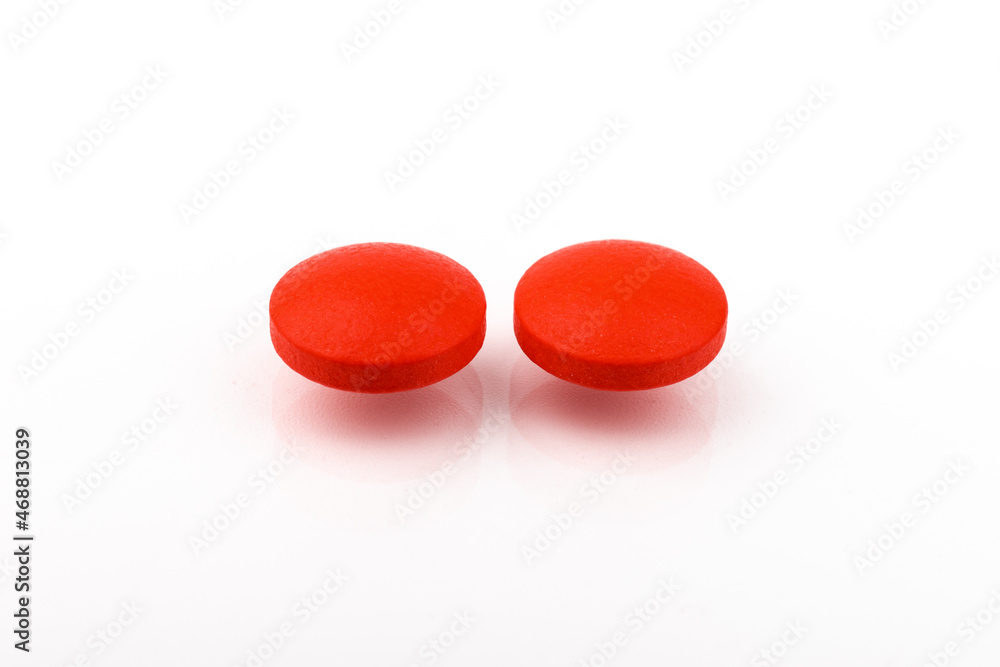 Wall mural Red pills on a white background, isolated. Pharmacy. Treatment.