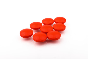 Red pills on a white background, isolated. Pharmacy. Treatment.