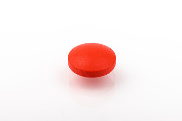 Red pills on a white background, isolated. Pharmacy. Treatment.
