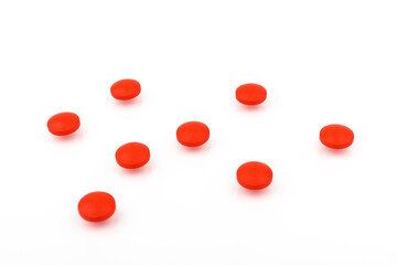 Red pills on a white background, isolated. Pharmacy. Treatment.