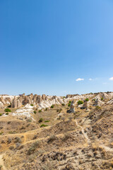 Fototapeta na wymiar Panorama of unique geological formations at Cappadocia at sunny day, Central Anatolia, Turkey.