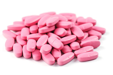 Pink vitamin pills for women on a white background.