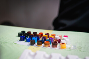 Close-up of tattoo artist work place parts and paint, machines and other equipment. Professional...