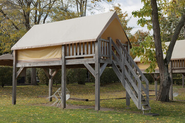 Tent off the ground on a wooden structure